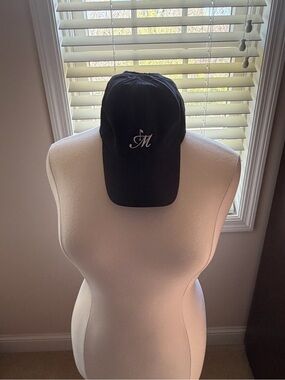 2 pony tail Callaway hats one Black and Pink Cap with Script 'M' Logo